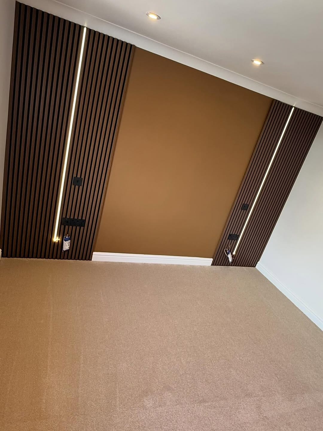 Bedroom slatted wood panelling with vertical LED strip lighting